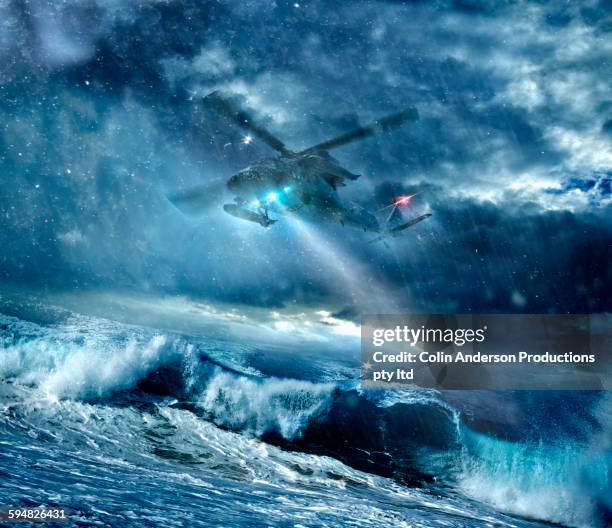 helicopter flying over stormy seas - cloud save stock pictures, royalty-free photos & images