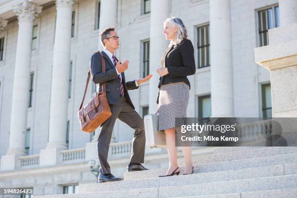 business people talking on courthouse steps - 2 steps stock-fotos und bilder