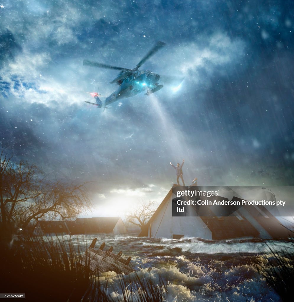 Helicopter saving Caucasian people from flooded house