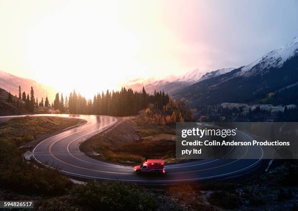 ambulance driving on winding remote road - ambulance photos et images de collection