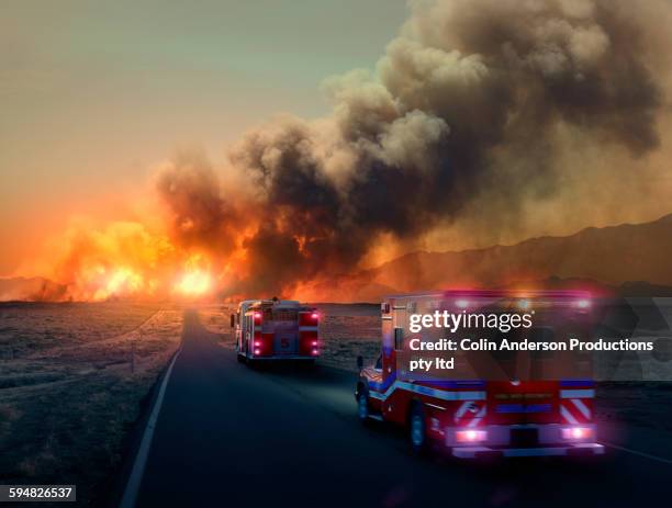 ambulance driving to forest fire in desert - naturkatastrophe stock-fotos und bilder