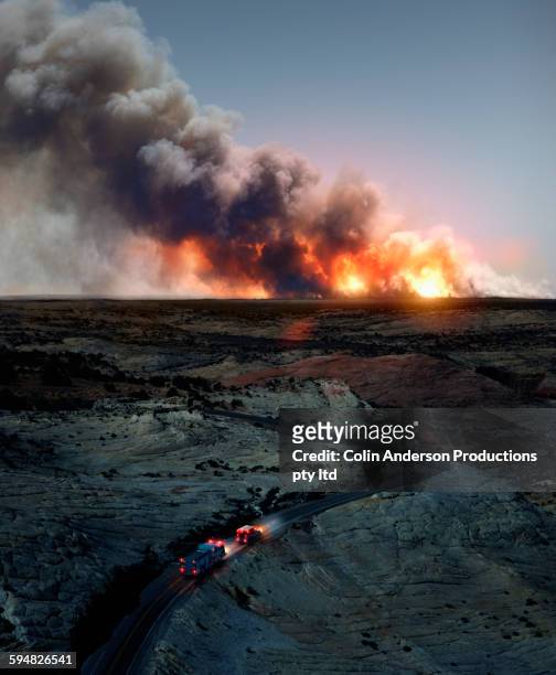 ambulance driving to wildfire in desert - distruzione foto e immagini stock