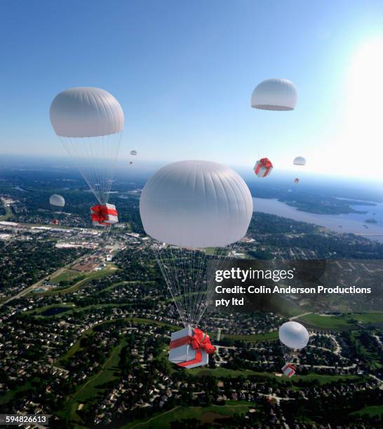 high angle view of gifts parachuting over suburban cityscape - falls texas stock pictures, royalty-free photos & images