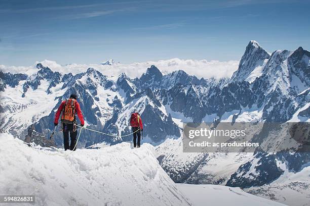 caucasian skiers walking on mountaintop, mont blanc, chamonix, france - chamonix stock pictures, royalty-free photos & images