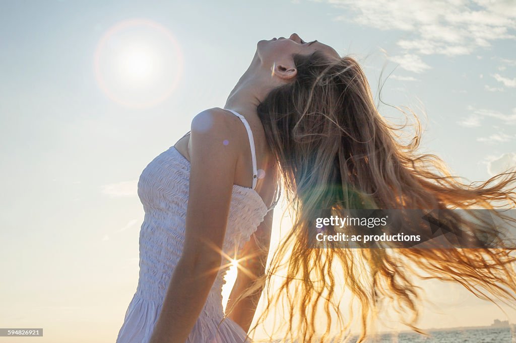 Caucasian woman tossing her hair outdoors