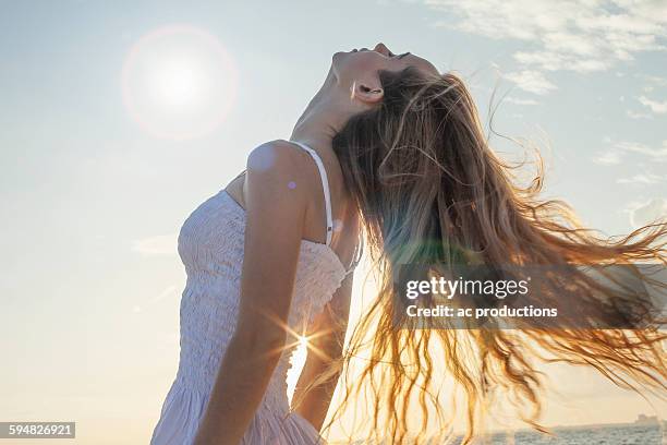 caucasian woman tossing her hair outdoors - human hair bildbanksfoton och bilder