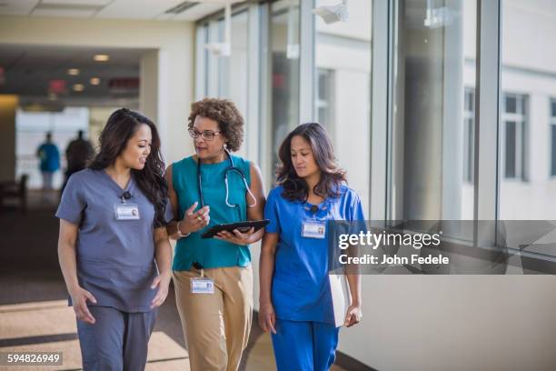 nurses and doctor using digital tablet - medical occupation ストックフォトと画像