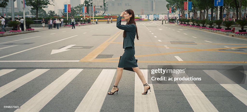 Chinese businesswoman in pedestrian crossing