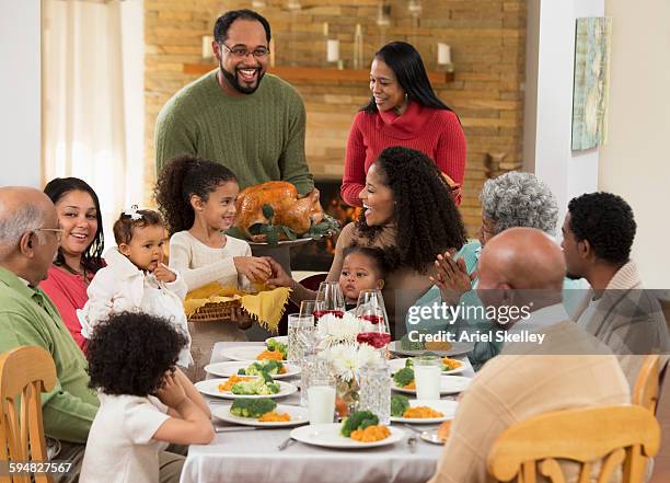 family eating thanksgiving dinner - american diner stockfoto's en -beelden