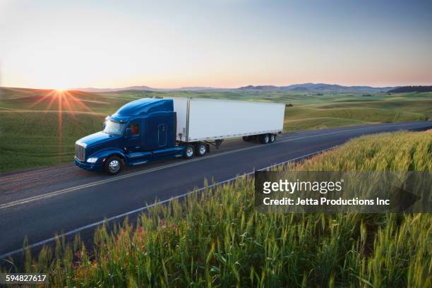 truck driving on remote highway - 大型トレーラー ストックフォトと画像