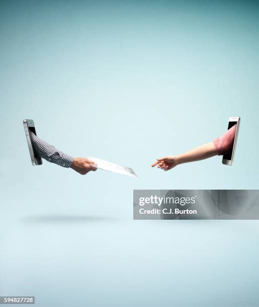 one arm reaching out resume out of smart phone to another arm coming from another smart phone - exchanging bildbanksfoton och bilder