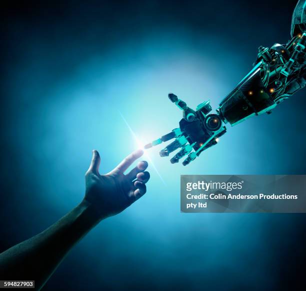 caucasian woman touching robot arm - human finger stock pictures, royalty-free photos & images