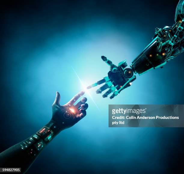 caucasian woman with bionic technology touching robot arm - human finger stock pictures, royalty-free photos & images