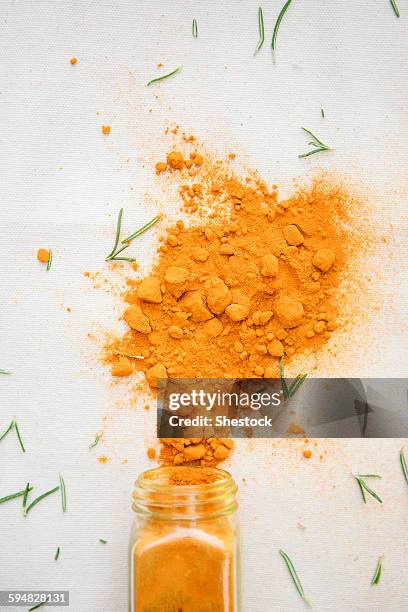 jar of spilled spices and herbs - spices stock pictures, royalty-free photos & images