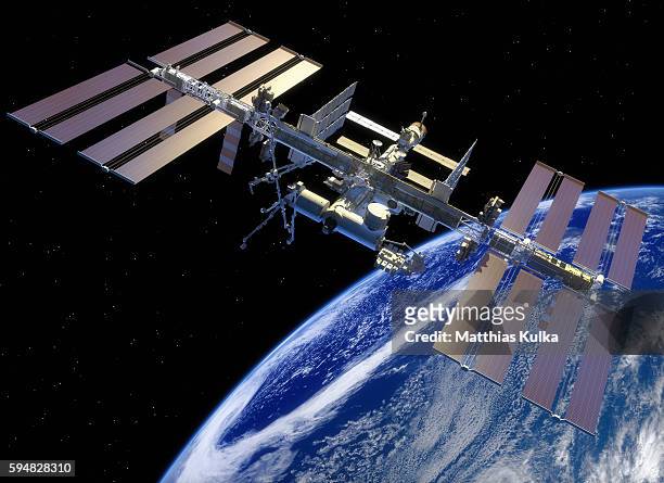 iss in earth orbit - international space station stock pictures, royalty-free photos & images