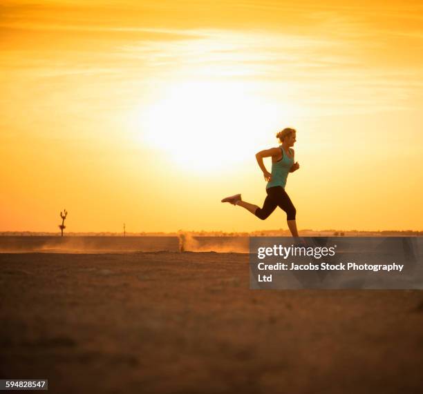 caucasian woman running in desert - hot arab women stock-fotos und bilder