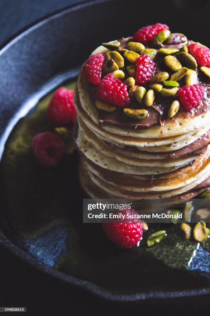 Pistachios and raspberries on pancakes