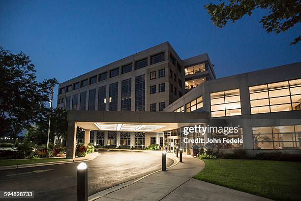 illuminated driveway of hospital at night - hospital exterior night fotografías e imágenes de stock