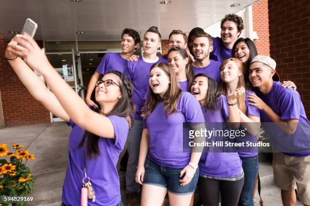 college students taking selfie outside dormitory - photography studios stockfoto's en -beelden