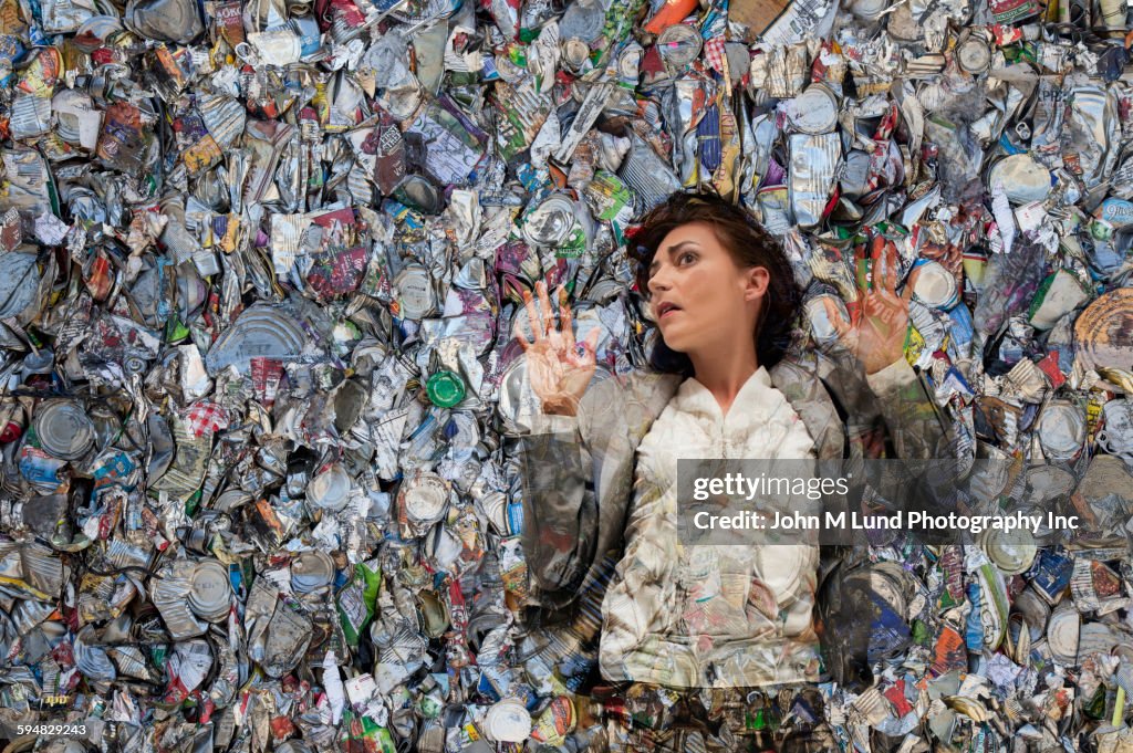 Woman laying in pile of compacted trash