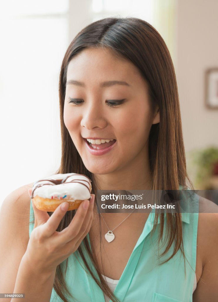 Chinese woman eating donut