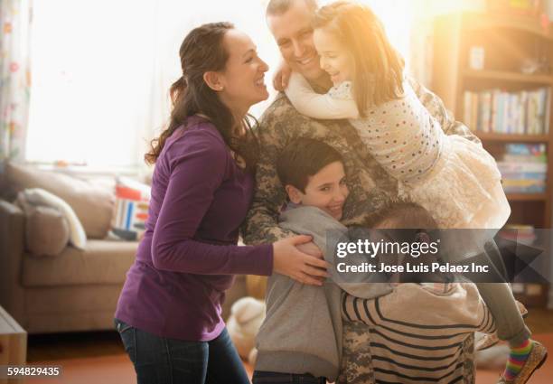 caucasian family greeting returning soldier - three children only stock pictures, royalty-free photos & images