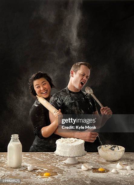 messy couple baking cake - excitement asian stock pictures, royalty-free photos & images