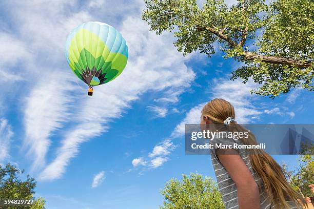 caucasian girl watching hot air balloon - balloon girl stock pictures, royalty-free photos & images