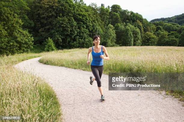 mixed race woman running on path - baden baden stock pictures, royalty-free photos & images