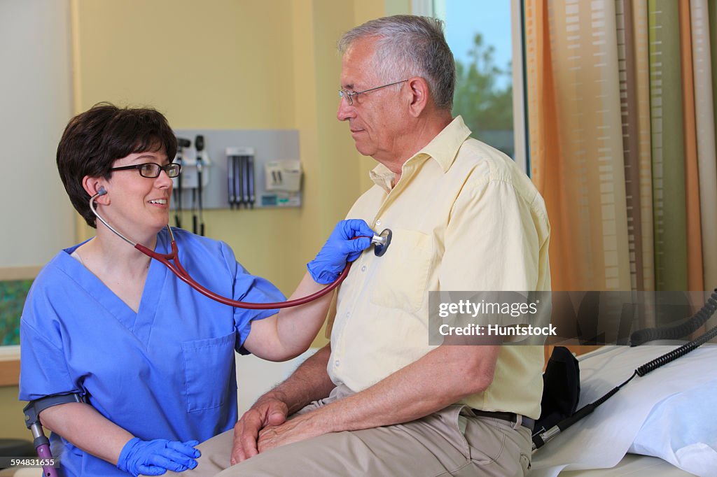 Nurse with Cerebral Palsy checking a patients heart in a clinic