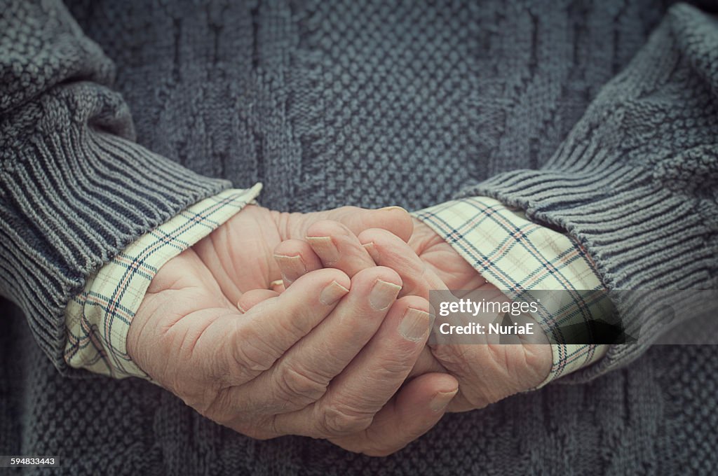 Rear view of a man holding hands behind his back