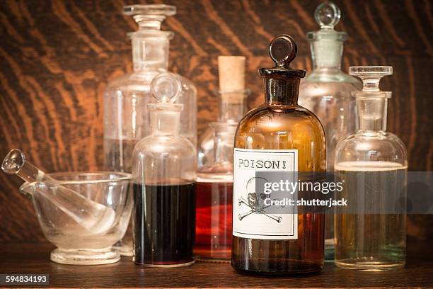 glass bottles with poison label - toxin stockfoto's en -beelden