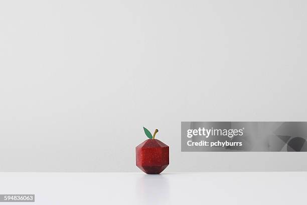 red apple crafted into geometric shape imitating paper origami - paper art stock pictures, royalty-free photos & images