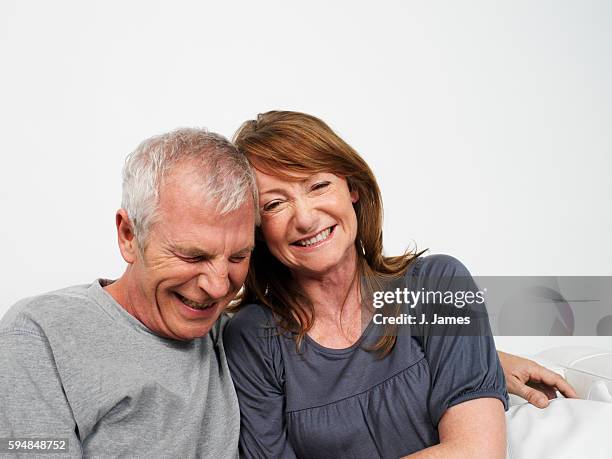 couple laughing together - couples studio portrait stock pictures, royalty-free photos & images