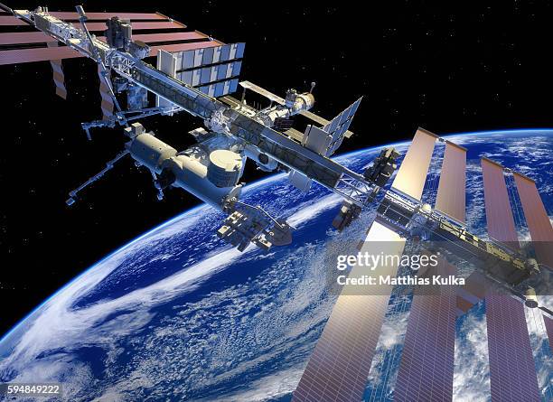 iss in earth orbit, closer view - outer space satellite stock pictures, royalty-free photos & images