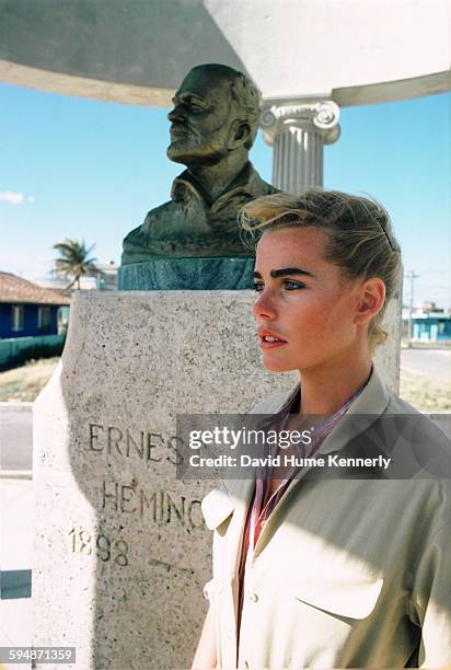 Actress and model Margaux Hemingway stands next to a bust of her grandfather, Ernest Hemingway, February 1978 in the village of Cojimar, Cuba.