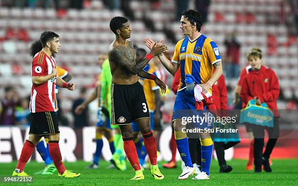 Patrick van Aanholt of Sunderland shakes hands with Louis Dodds of Shrewsbury Town after the EFL Cup second round match between Sunderland and...