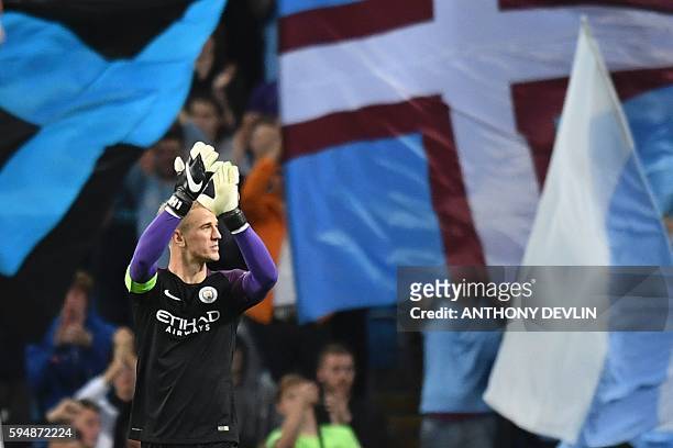 Manchester City's English goalkeeper Joe Hart gestures to the crowd after the UEFA Champions League second leg play-off football match between...