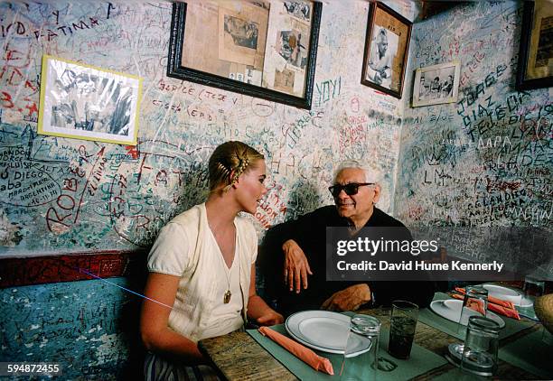 Actress and model Margaux Hemingway talking to owner Angel Martínez at the restaurant-bar, La Bodeguita del Medio, February 1978 in Havana, Cuba. The...