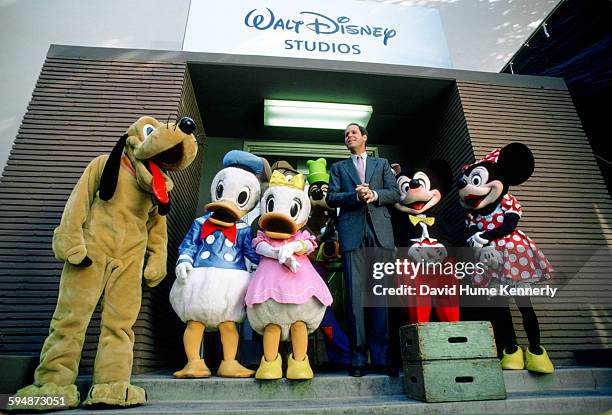 Disney's CEO, Michael Eisner, poses with popular Disney characters outside one of the company's buildings, December 18 in Burbank, California.
