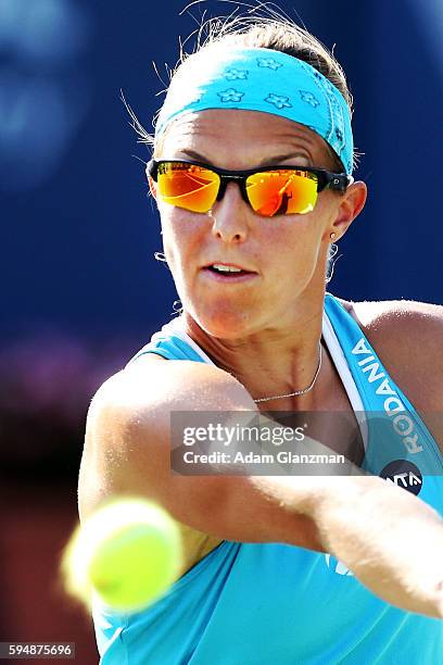 Kirsten Flipkens of Belgium returns a shot during her match against Caroline Garcia on day 4 of the Connecticut Open at the Connecticut Tennis Center...