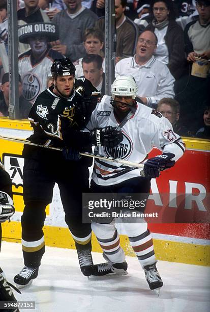 Derian Hatcher of the Dallas Stars battles with Georges Laraque of the Edmonton Oilers during Game 3 of the 2000 Conference Quarter-Finals on April...
