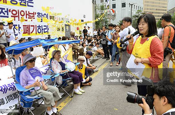 Activists gather around a statue of a girl in front of the Japanese Embassy in Seoul that symbolizes the so-called "comfort women" on Aug. 24 after...