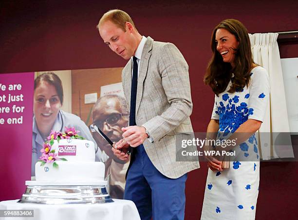 Catherine, Duchess of Cambridge and Prince William, Duke of Cambridge cut a 25th anniversary cake during their visit to Keech Hospice Care on August...