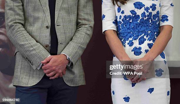 Catherine, Duchess of Cambridge and Prince William, Duke of Cambridge, clothing detail, listen to a speech during their visit to Keech Hospice Care...