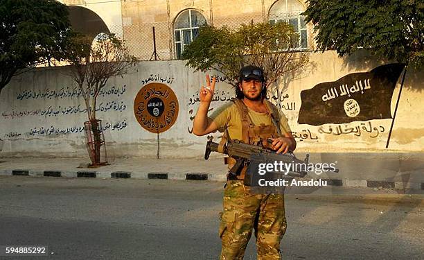 Member of Free Syrian Army flashes victory sign as he patrols in Jarabulus district of Aleppo, Syria after taking control of the district's centrum...