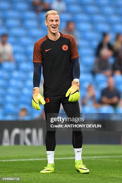 Manchester City's English goalkeeper Joe Hart warms up ahead of the UEFA Champions League second leg play-off football match between Manchester City...