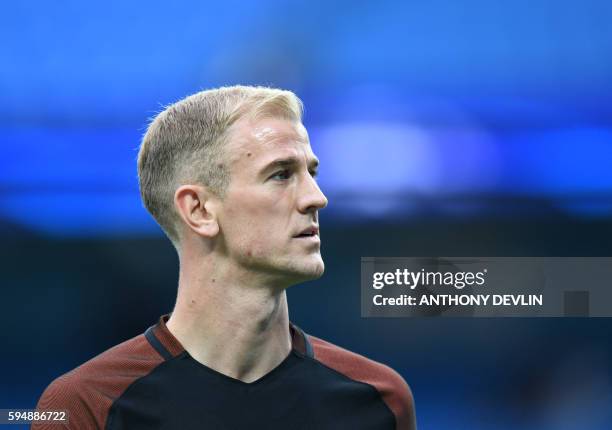 Manchester City's English goalkeeper Joe Hart warms up ahead of the UEFA Champions League second leg play-off football match between Manchester City...