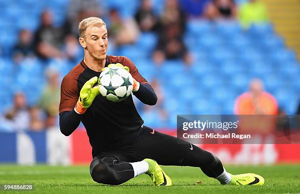 Joe Hart of Manchester City warms up prior to the UEFA Champions League Play-off Second Leg match between Manchester City and Steaua Bucharest at...