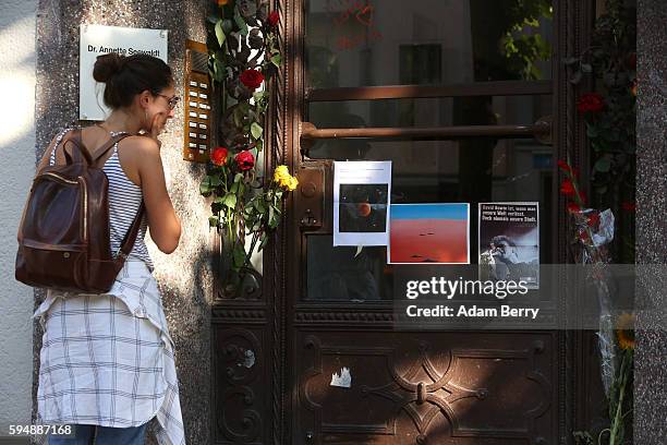 Visitor looks at pictures left in honor of British musician David Bowie at his former residence on August 24, 2016 in Berlin, Germany. Bowie, who...